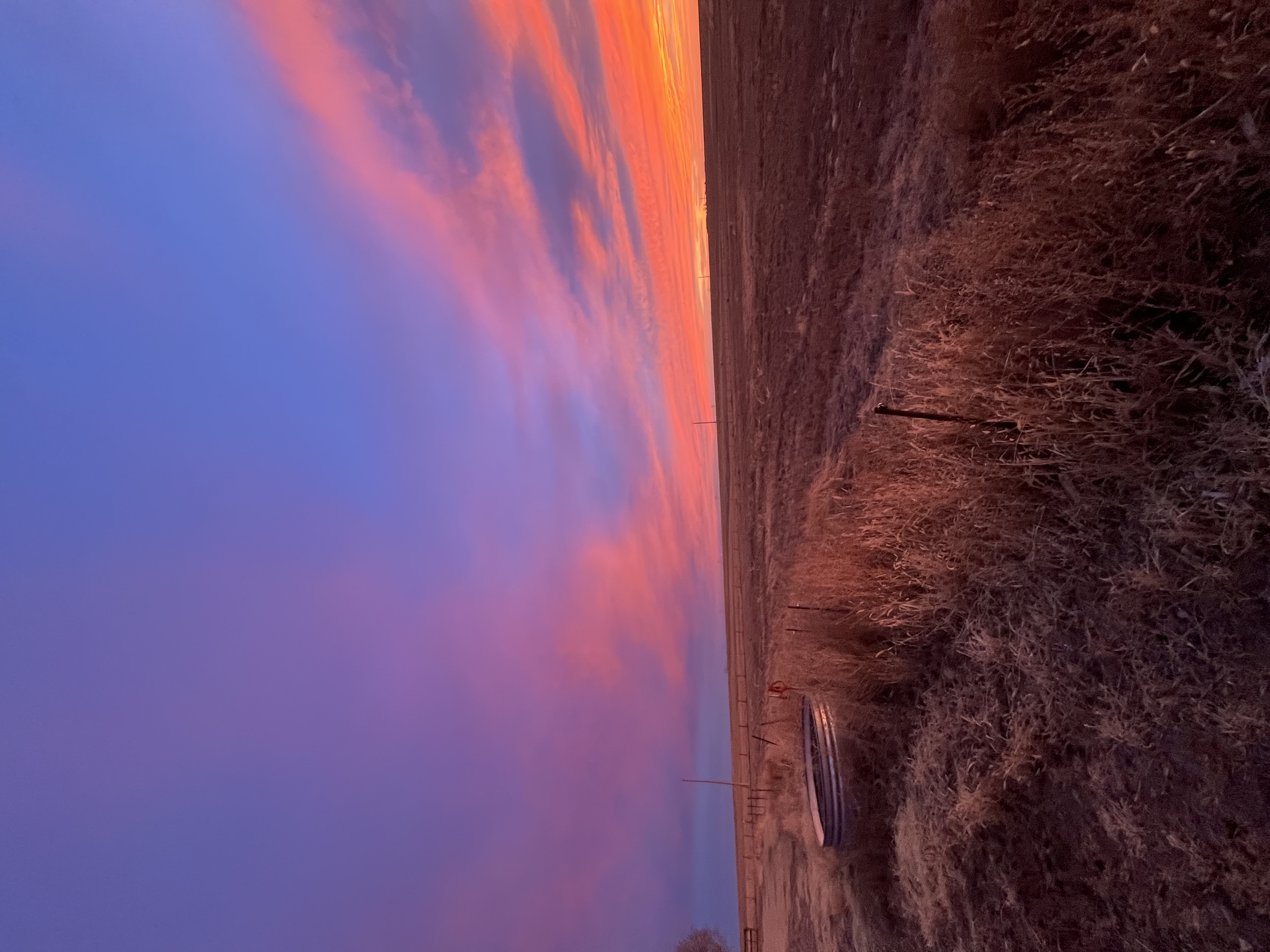 Fiery sunrise over the plains stock tank